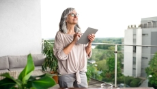 A woman using a tablet at her desk A woman using a tablet at her desk