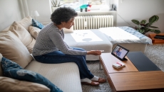 An older woman talking to a provider using a tablet. An older woman talking to a provider using a tablet.