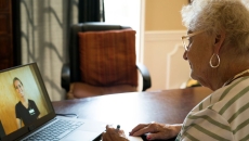 An older woman talking to a provider through a video call on her laptop An older woman talking to a provider through a video call on her laptop