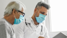 An older man and his doctor looking at a tablet An older man and his doctor looking at a tablet
