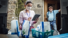 A woman wearing a mask delivering medications. A woman wearing a mask delivering medications.