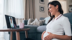 A pregnant person talks to a provider via telehealth A pregnant person talks to a provider via telehealth