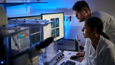 Researchers looking at data on a computer Researchers looking at data on a computer