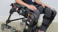 A person wearing the prototype hybrid wheelchair and exoskeleton A person wearing the prototype hybrid wheelchair and exoskeleton