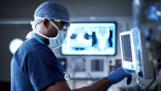 A surgeon looking at a monitor. A surgeon looking at a monitor.