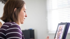 A woman talking to a provider using a tablet A woman talking to a provider using a tablet