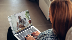 A person talking to a provider through a video chat on a laptop A person talking to a provider through a video chat on a laptop