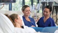 Virtus Health nurses assisting a patient in bed Virtus Health nurses assisting a patient in bed