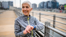 A person using a smartwatch while exercising. A person using a smartwatch while exercising.