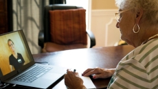 Person talking with nurse on laptop Person talking with nurse on laptop