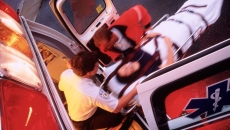 Responders move a patient on a stretcher inside the ambulance