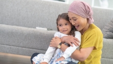 A woman holding a child while playing A woman holding a child while playing