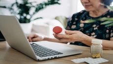 A woman looking up prescription prices online A woman looking up prescription prices online
