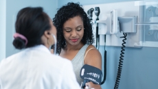 A provider checking blood pressure during an appointment A provider checking blood pressure during an appointment