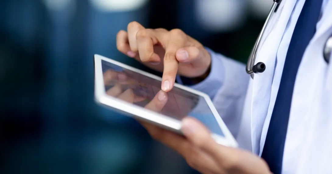 Clinician looking at a tablet computer Clinician looking at a tablet computer