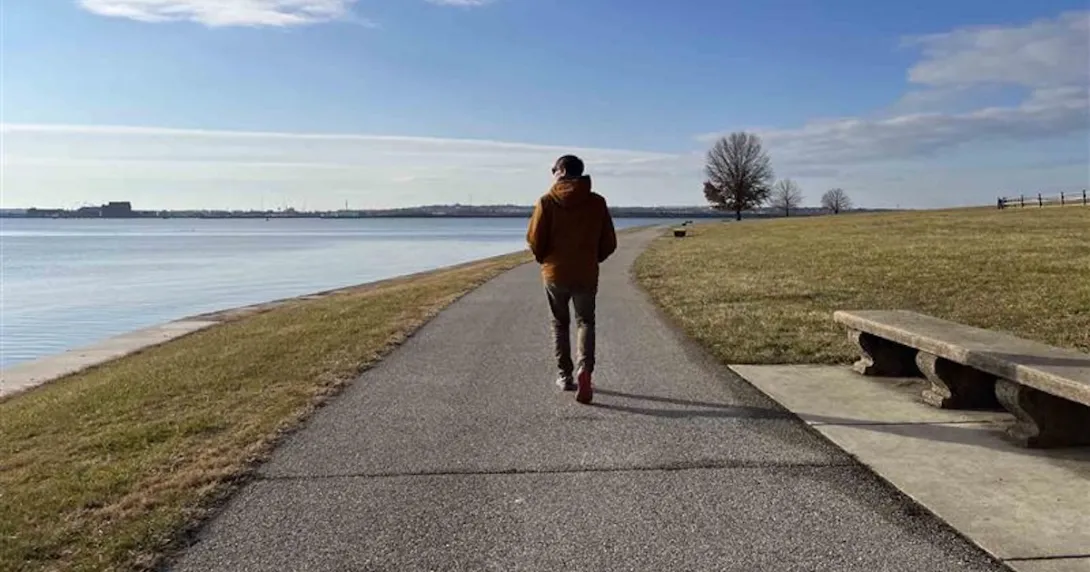 Person walking near an ocean Person walking near an ocean