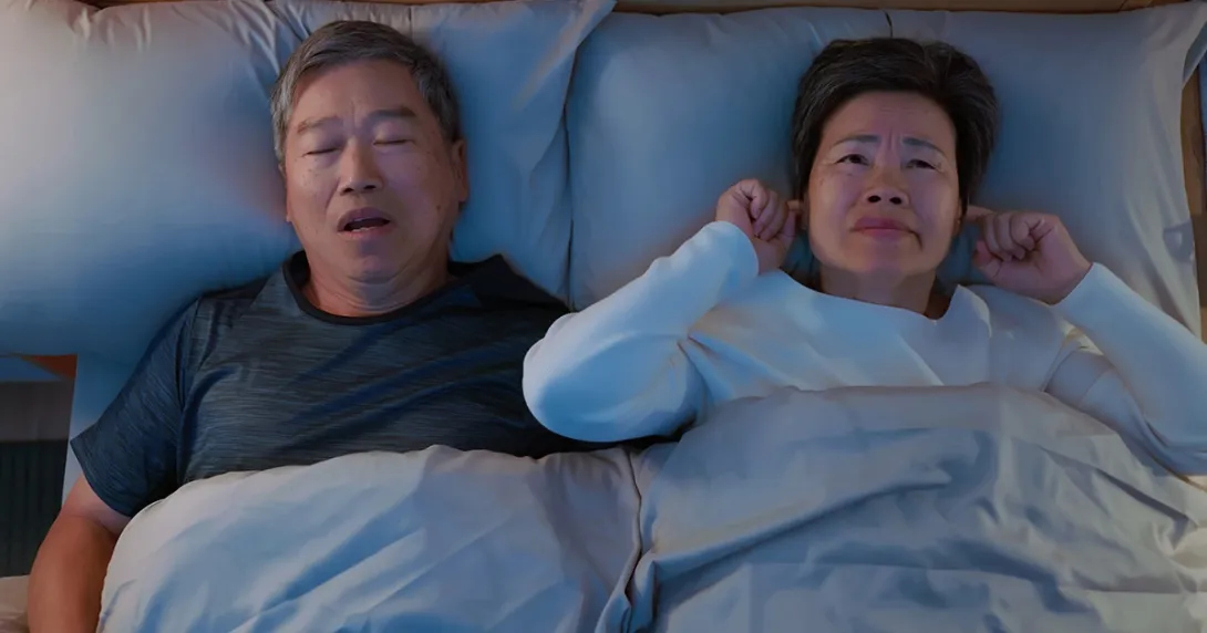 Man with sleep apnea in bed with his wife