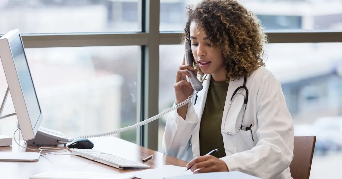 Healthcare professional talking on the telephone Healthcare professional talking on the telephone