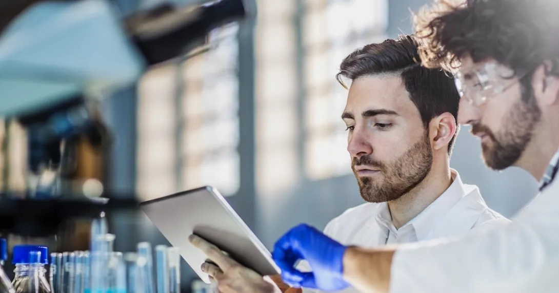 Two researchers looking at a tablet computer  Two researchers looking at a tablet computer