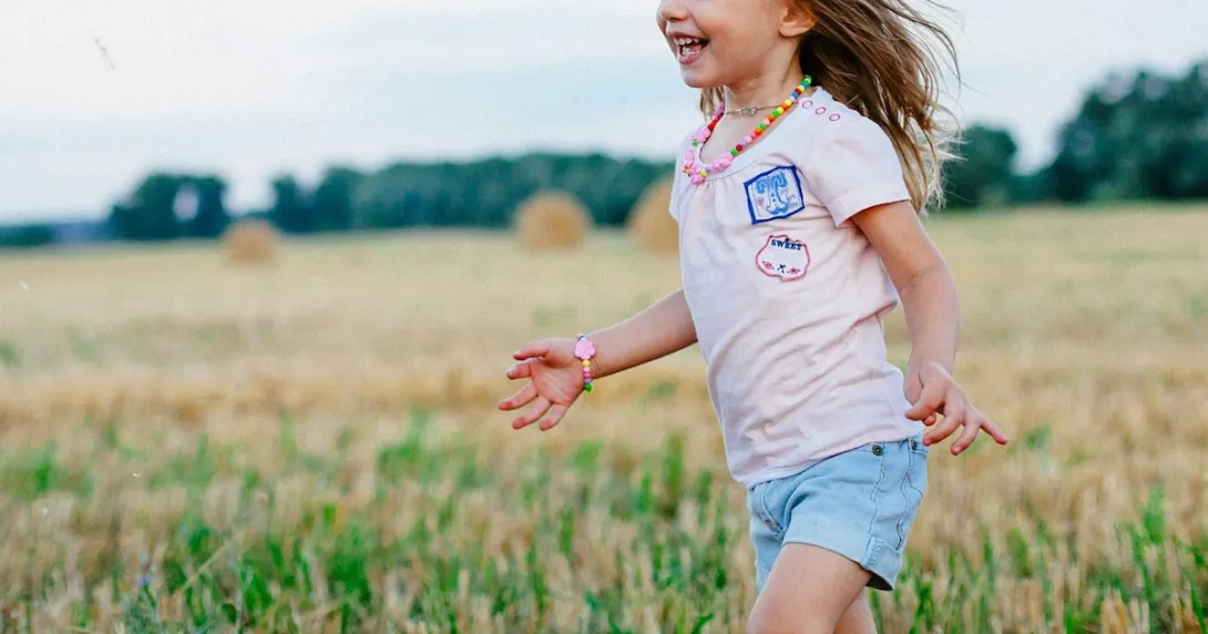 A child running in a field A child running in a field