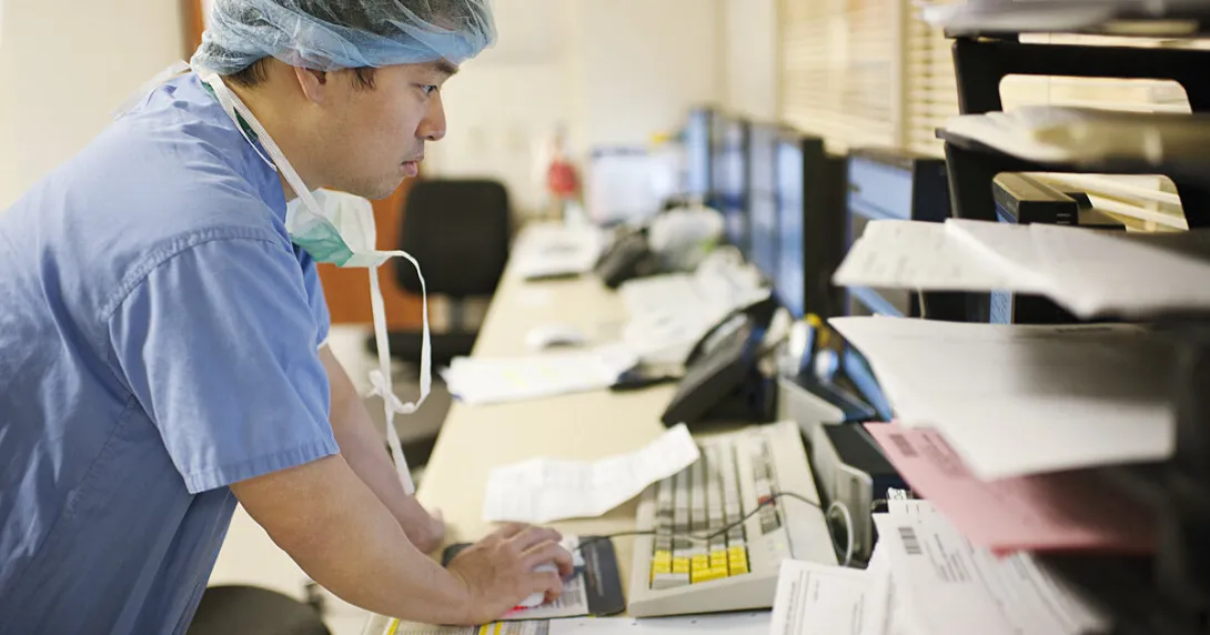 A surgeon checking on a patient's records