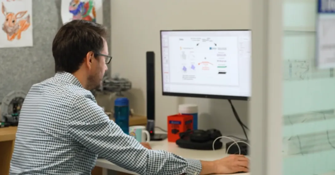 DT-GPT lead researcher and UniMelb A/Prof Michael Menden using a desktop computer