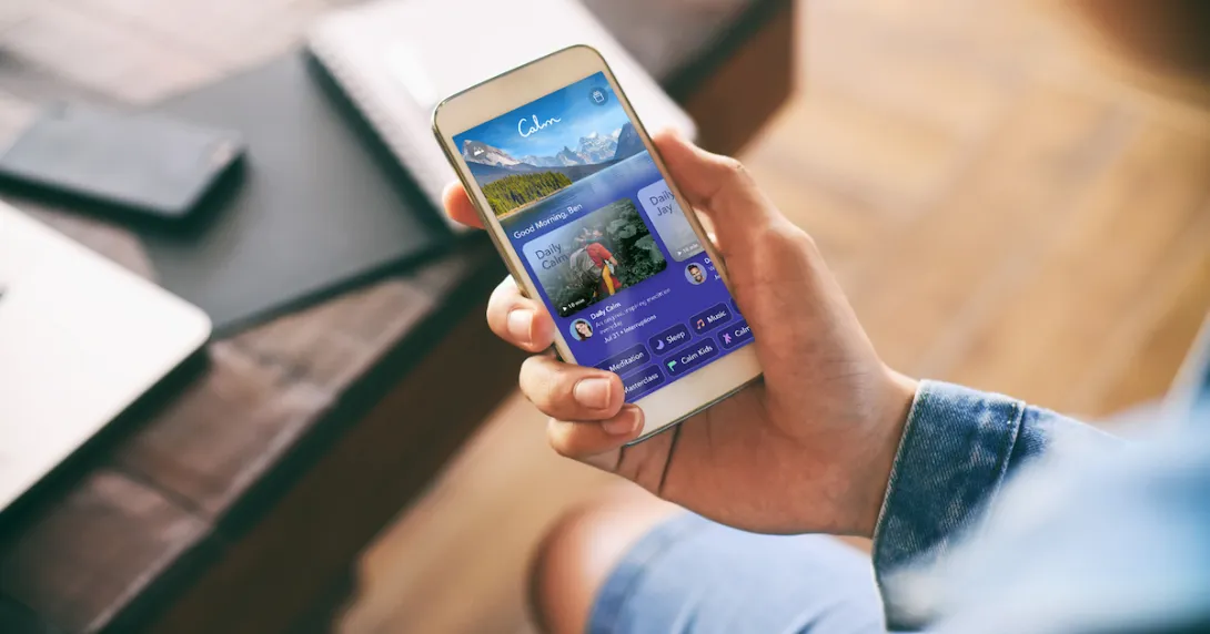 A close-up of a person using the Calm app on a smartphone. A close-up of a person using the Calm app on a smartphone.