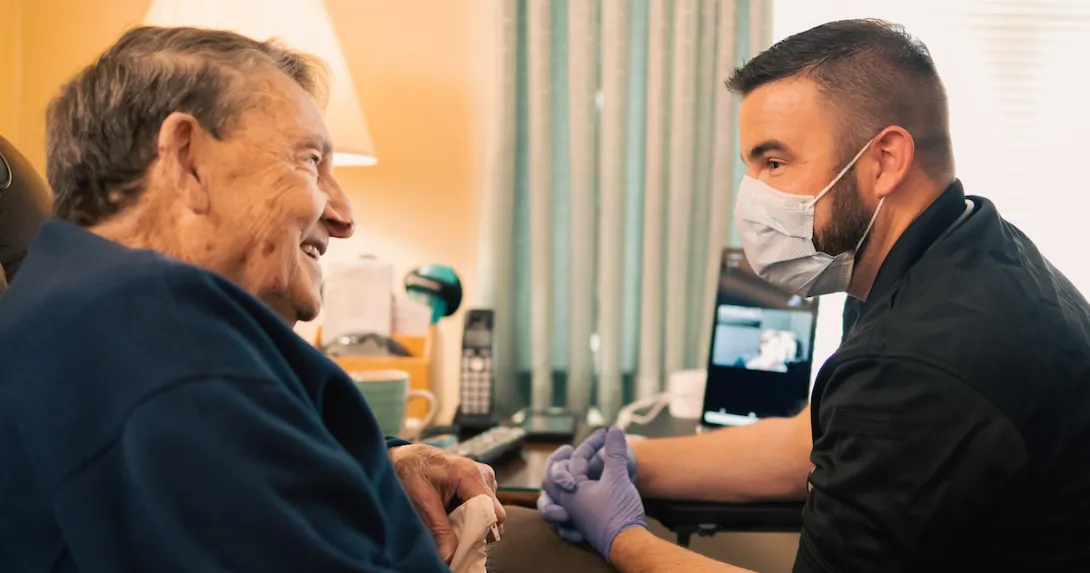 An Atrium Health community paramedic consults with patient in his home. An Atrium Health community paramedic consults with patient in his home.