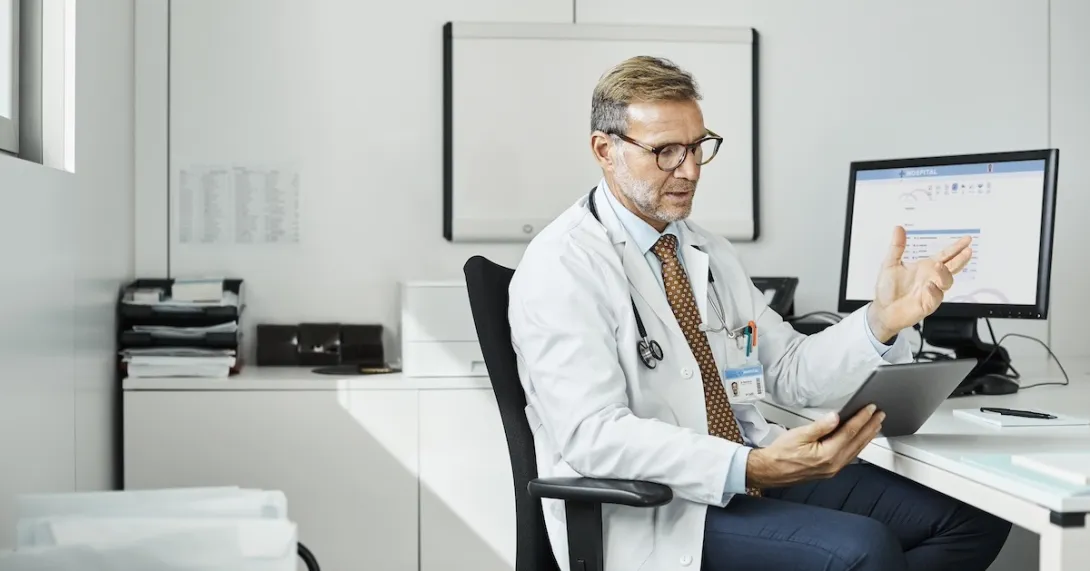 Healthcare practitioners consulting with person on mobile device