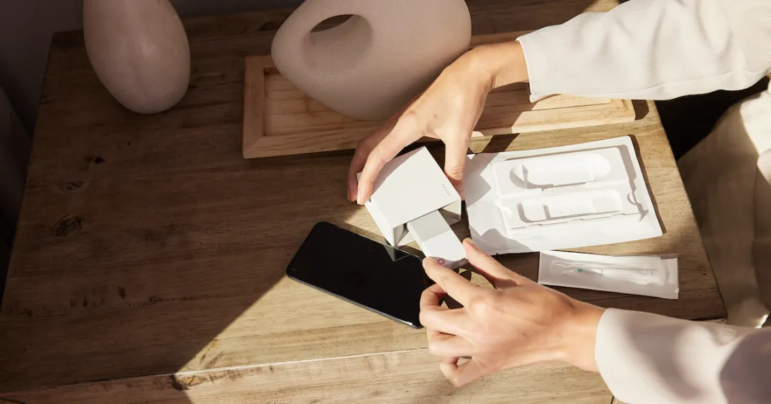 A person unboxing a Cue test. A person unboxing a Cue test.