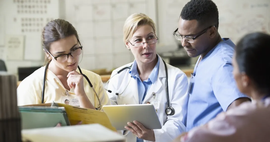 Healthcare professionals reviewing patient chart on a tablet computer Healthcare professionals reviewing patient chart on a tablet computer