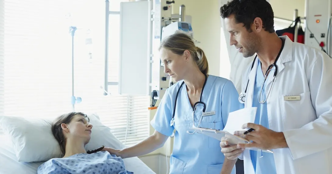 Healthcare professionals consulting with a patient Healthcare professionals consulting with a patient