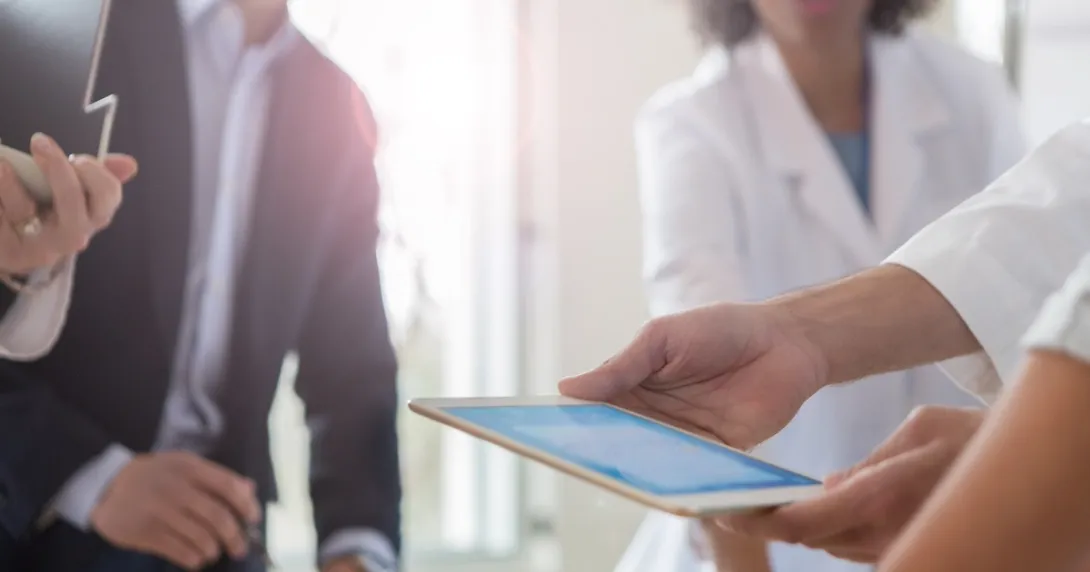 Employees reviewing data on a tablet