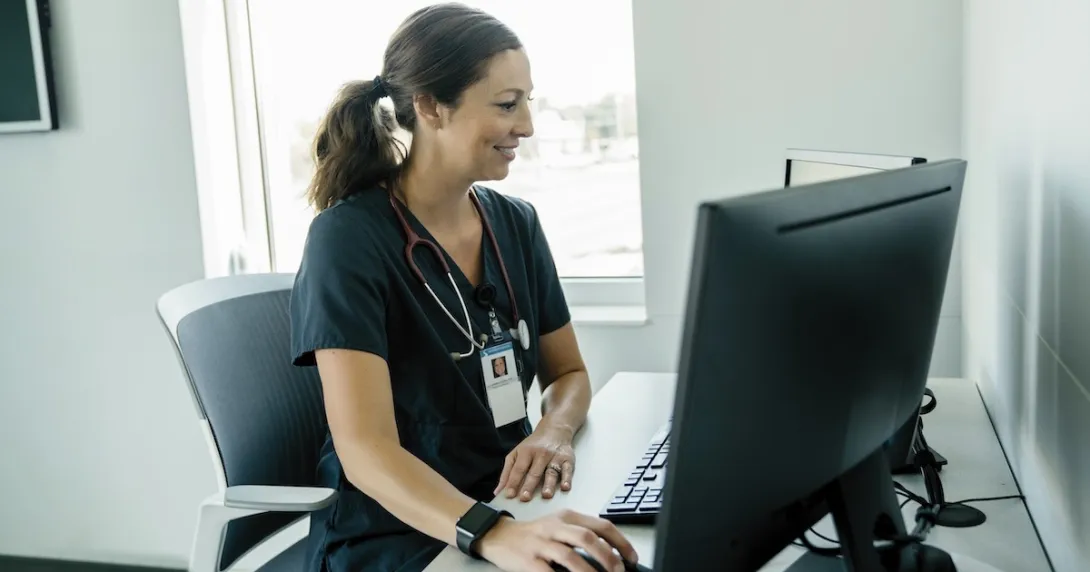 Healthcare professional looking at a PC screen Healthcare professional looking at a PC screen