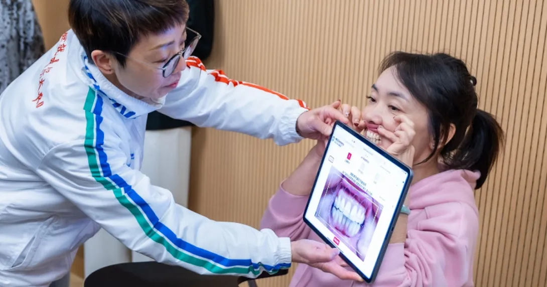 A dentist screening a person's gum using an AI-powered mobile application A dentist screening a person's gum using an AI-powered mobile application