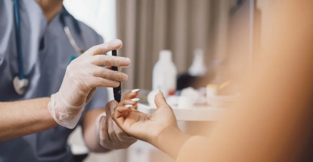 Doctor taking a patient's blood sample in a clinic Doctor taking a patient's blood sample in a clinic