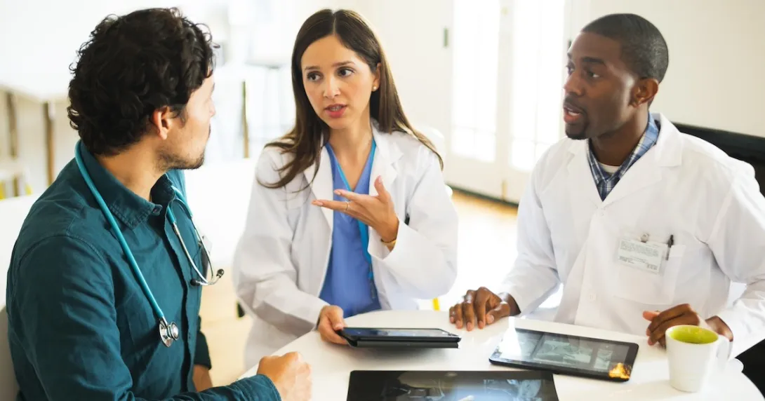 Healthcare professionals reviewing and discussing clinical data Healthcare professionals reviewing and discussing clinical data