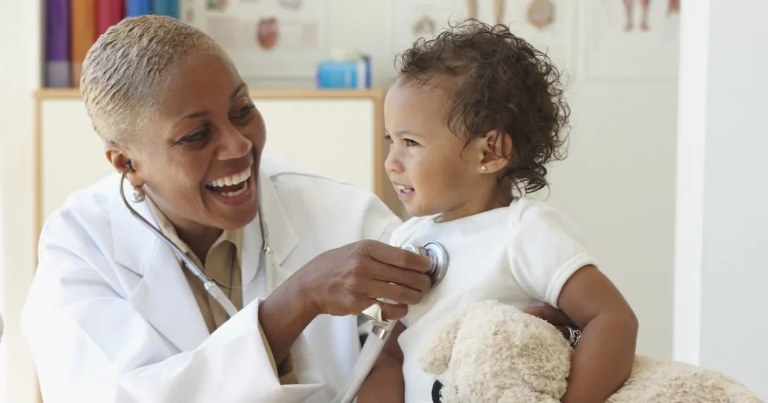 Healthcare provider checking a small patient Healthcare provider checking a small patient