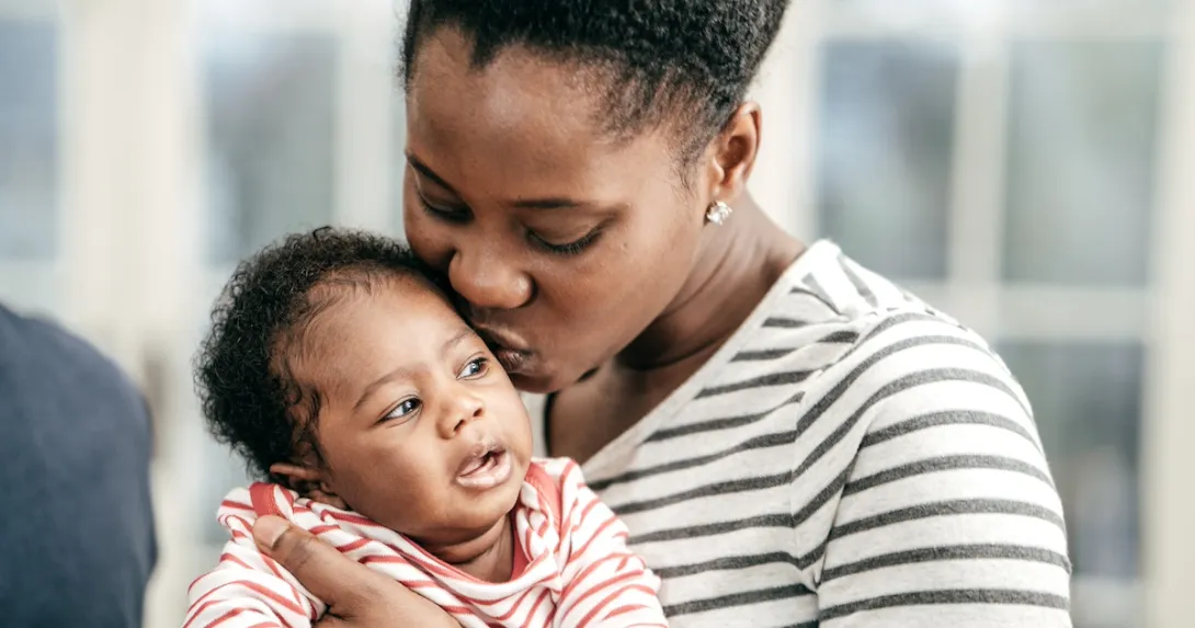 A person holds an infant A person holds an infant
