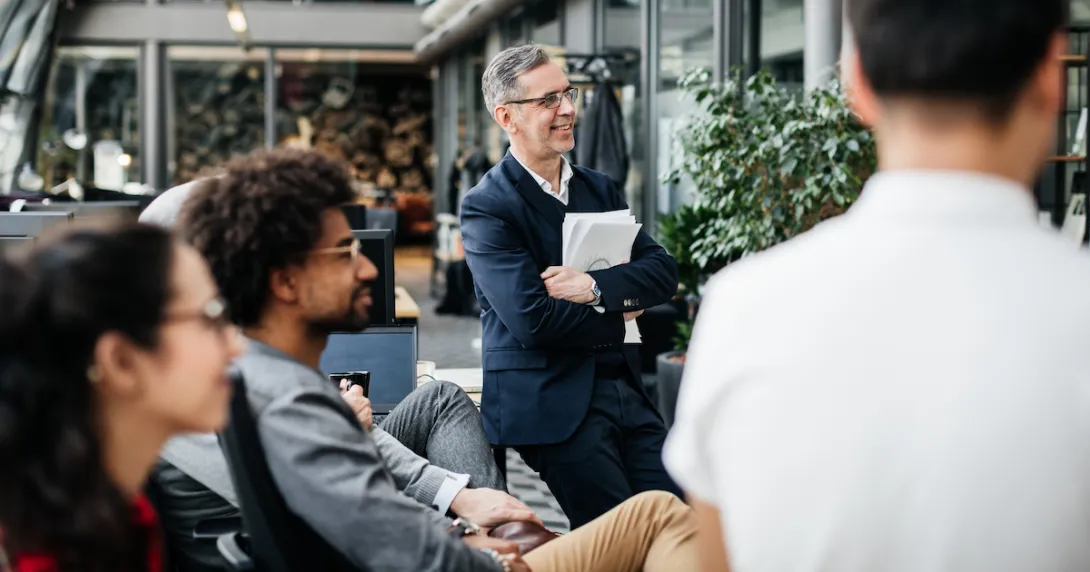 Numerous people sitting in a courtyard seated as though they are all looking at something Numerous people sitting in a courtyard seated as though they are all looking at something