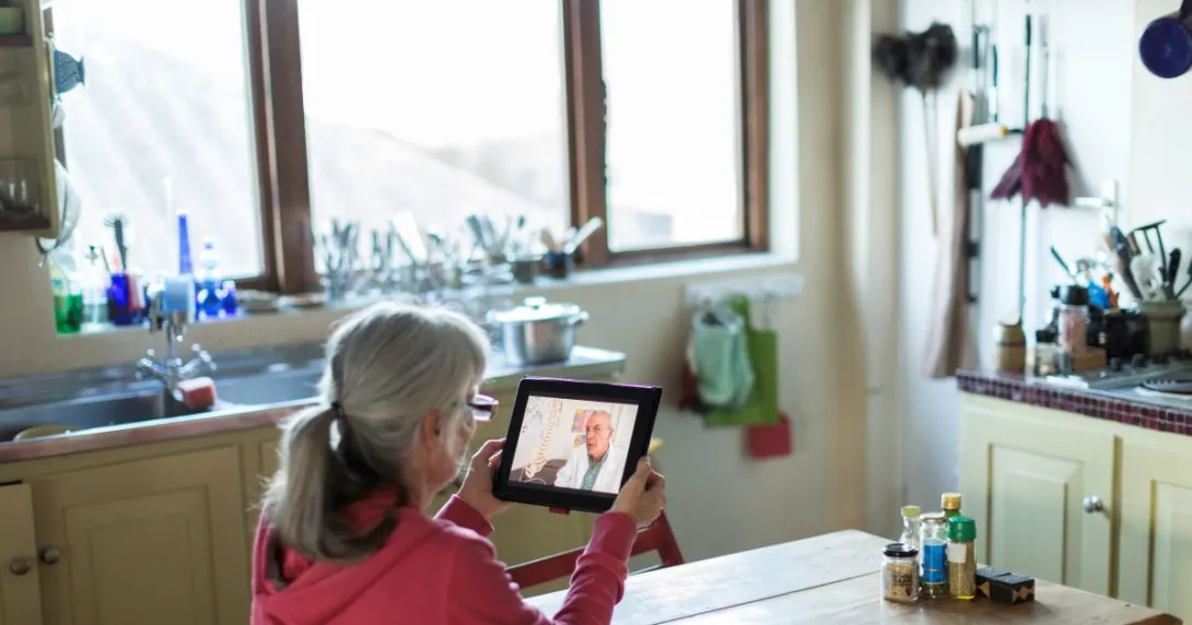 person holding tablet sitting at table person holding tablet sitting at table