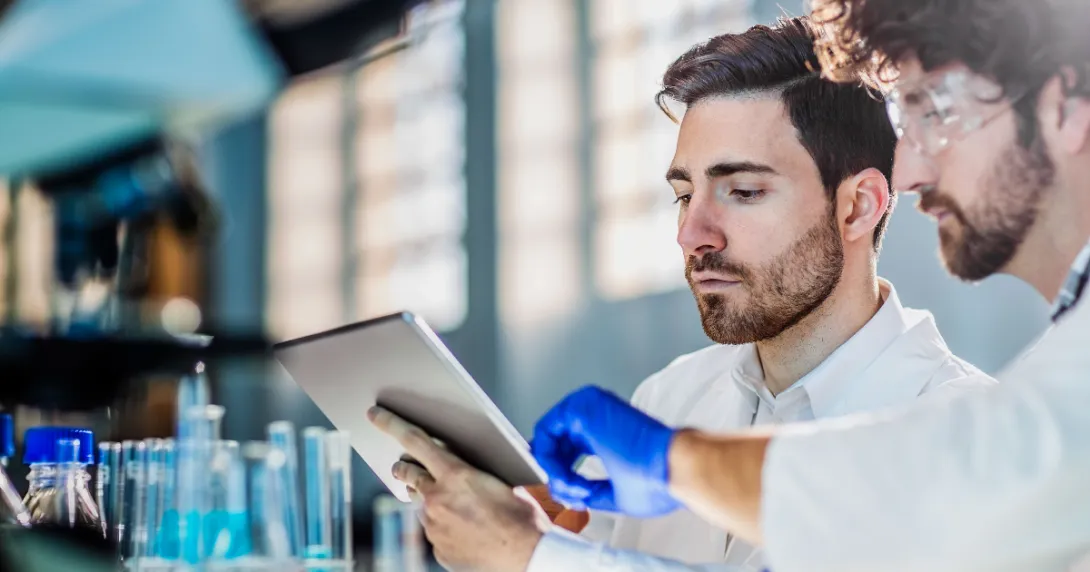 Two people looking at a tablet in a laboratory Two people looking at a tablet in a laboratory