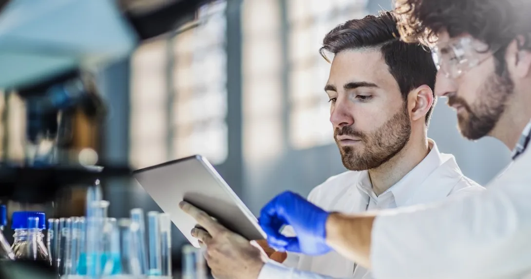 Two researchers in a laboratory using a digital tablet Two researchers in a laboratory using a digital tablet