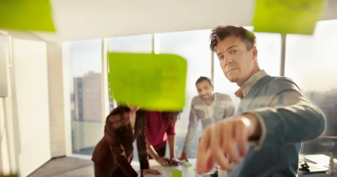 people looking at sticky notes People looking at sticky notes