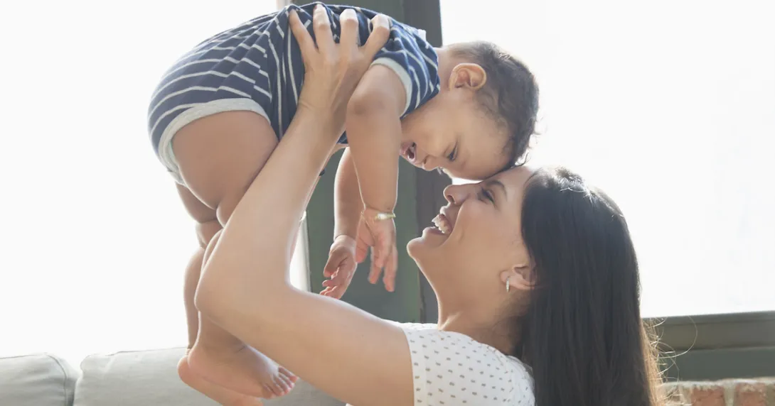 Person holding another smaller person above their head Person holding another smaller person above their head