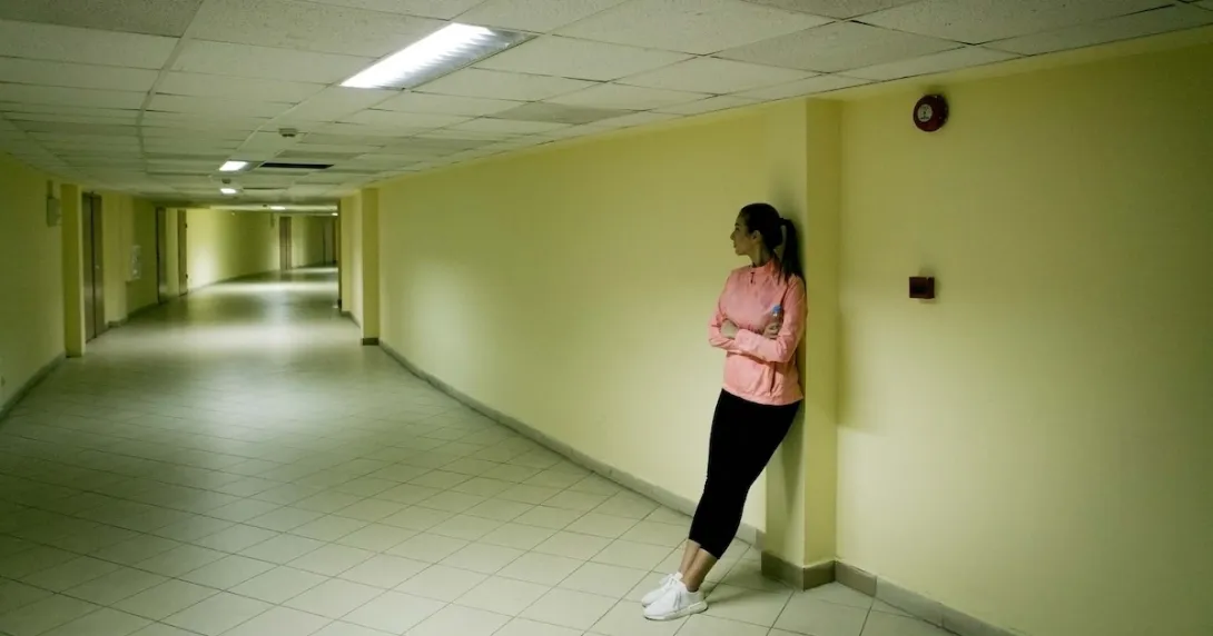 Person standing in the hall of a halfway house Person standing in the hall of a halfway house