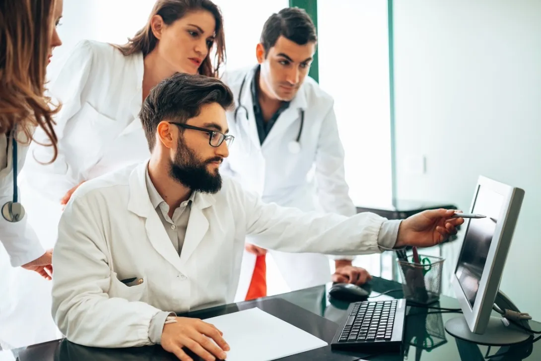 Healthcare practitioners looking at ultrasound results Healthcare practitioners looking at ultrasound results