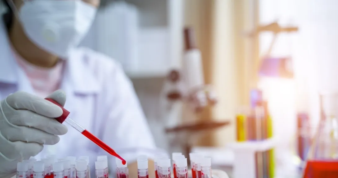 Clinician analyzing blood samples Clinician analyzing blood samples