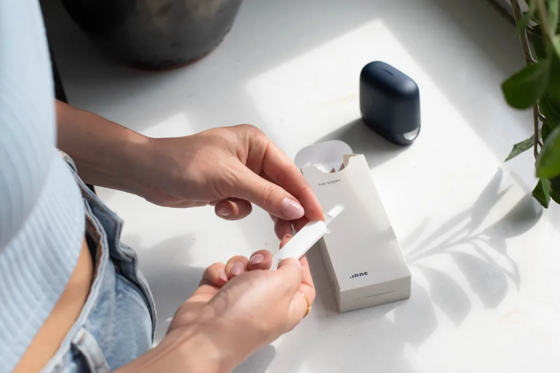 Also, British digital health startup Healum launches research network. Person holds a test strip. Healum, NHS, women's health