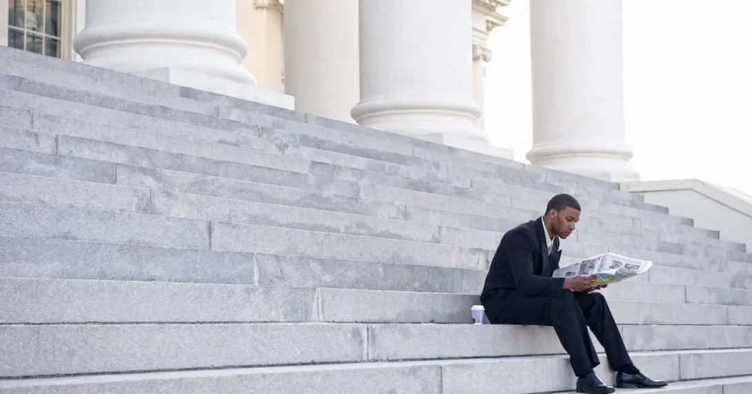 Man sitting on court building steps Man sitting on court building steps
